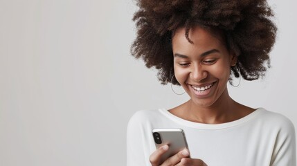 An African American woman grins while using her smartphone, evoking the pleasure of digital connectivity in everyday life - obrazy, fototapety, plakaty