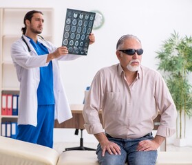 Old blind man visiting young male doctor