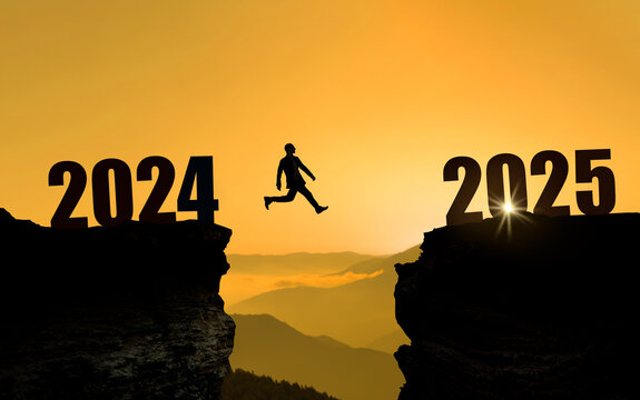 Man jumping from hill 2024 to hill 2025 at beautiful sunrise. New Year's concept. 2024 is coming to an end. Welcome to 2025. 