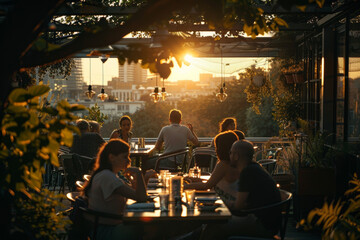People enjoying a meal at a rooftop restaurant bathed in golden sunlight against a backdrop of city buildings at sunset