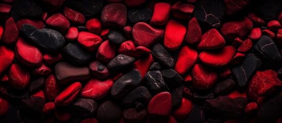 A collection of carmine and magenta rocks creating a striking pattern against an electric blue and black background, resembling a flowering plant in a font of entertainment