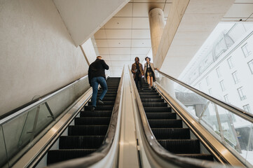 Diverse individuals using an escalator in a contemporary urban setting, capturing the concept of...