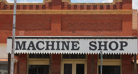 Fototapeta na wymiar Machine Shop Sign on Historic Building in Downtown Granger TX