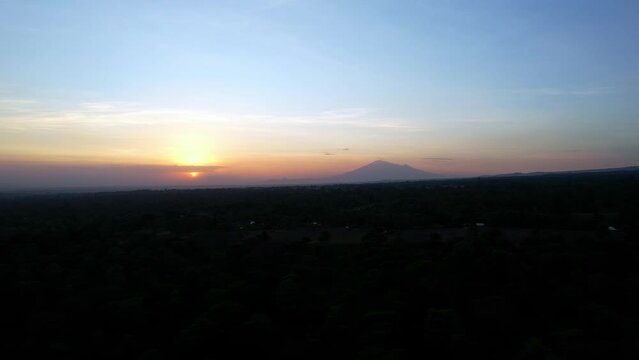 A hazy Africa Tanzania sunset over a Mount Meru close to Kilimanjaro creating a beautiful natural landscape 
