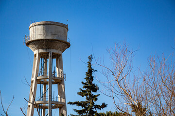 Water tower against blue sky. Water tower on a sky background. 