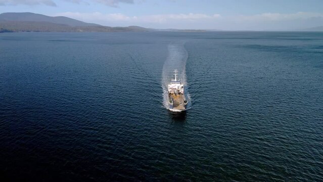 Offshore Supply Vessel Navigating On Tasman Sea In Bruny Island, Tasmania, Australia. aerial pullback shot