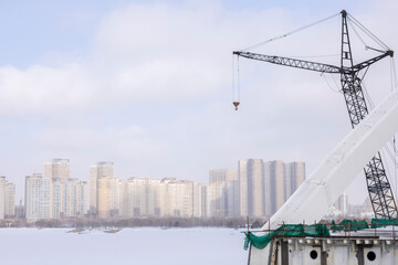 huge river loading cranes. on the river bank in winter
