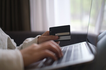 Hands holding credit debit card and using keyboard on laptop at home. Online shopping ,network...