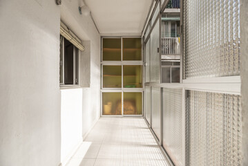 A small elongated terrace closed with aluminum and glass and a closet in the back made of the same material