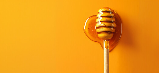 Honey dripping from a wooden stick isolated on a yellow background, Honey dripping from honey dipper isolate. Thick honey dipping from the wooden honey spoon. Healthy food and diet, bee