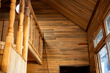 Wooden staircase with balustrade in the old wooden house closeup - obrazy, fototapety, plakaty