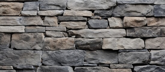 A detailed view of a stone wall with a multitude of rectangular bricks, showcasing the intricate brickwork and composite material used in the construction of the building