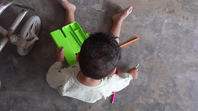A baby is playing with colored pencils on the floor, super slow motion 240fps 