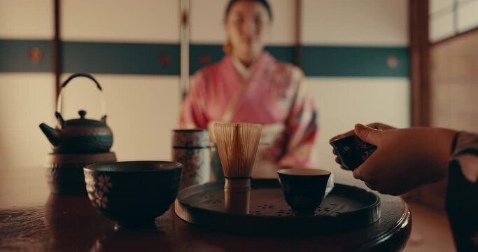 Hands, teapot and japanese women with tea with traditional matcha and indigenous herbs in home. Health, ceremony and people with herbal beverage for relaxing, wellness and detox for drinking ritual