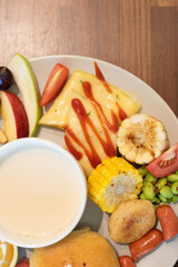 breakfast spread with fruit, eggs, and soup