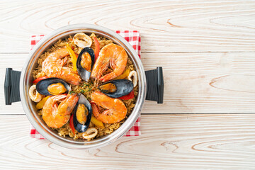 Seafood Paella with prawns, clams, mussels on saffron rice - obrazy, fototapety, plakaty