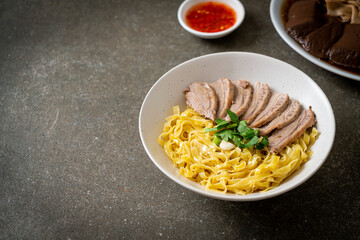 dried duck noodles in white bowl