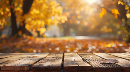 Naklejka na ściany i meble A wooden table surrounded by fallen leaves on the ground, creating a rustic and serene autumn scene in nature, orange fall leaves in park, sunny autumn natural background