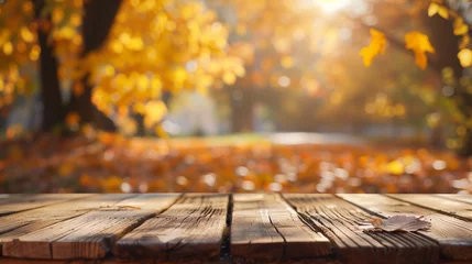Tafelkleed A wooden table surrounded by fallen leaves on the ground, creating a rustic and serene autumn scene in nature, orange fall leaves in park, sunny autumn natural background © Fokke Baarssen