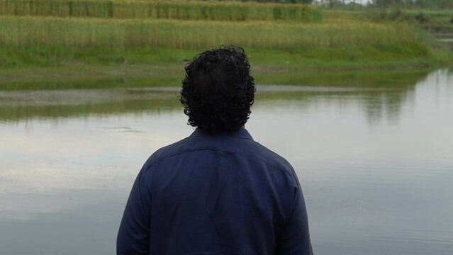 A Pakistani Man on a lake enjoying in nature scene, super slow motion 240fps 