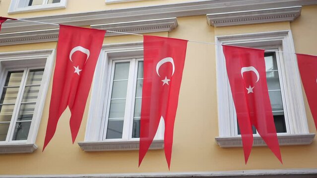A low angle shot of Turkish national flag hanging on a rope in the street