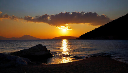 Beautiful sunset over the sea above mountains and islands. The sun goes down on the sea.