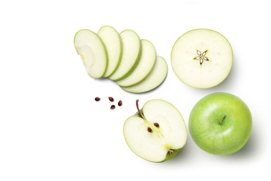 Green granny smith apple and cut in half sliced with seeds isolated on white background. top view, flat lay.