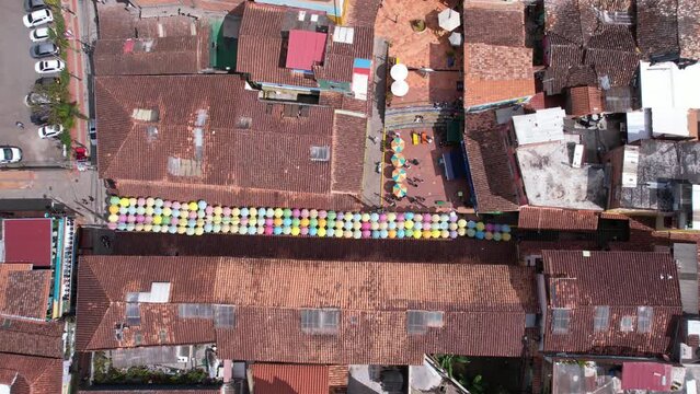 Aerial View of Guatape, Colombia. Town Buildings and Lake Coast on Sunny Day, Revealing Drone Shot