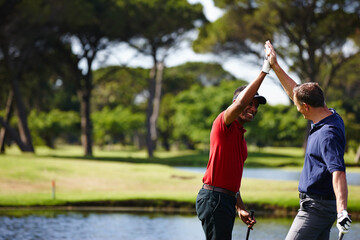 Excited man, high five and celebration with golf course for winning, point or score in outdoor nature. Male person, friends or people touching with smile for teamwork, victory or match on grass field