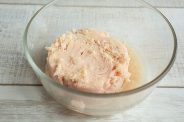 A view of a glass bowl of canned tuna.