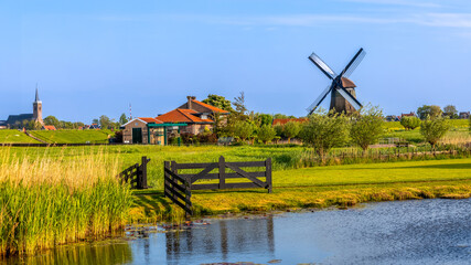 Historic windmill called Ondermolen K in Northern Netherlands