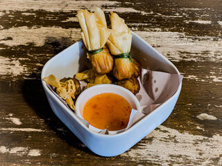 a bowl of food with dipping on a table