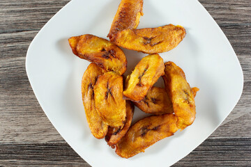 A top down view of a plate of fried plantains.