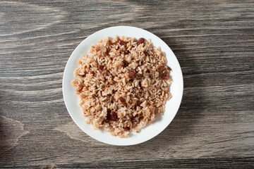 A top down view of a plate of rice and peas.