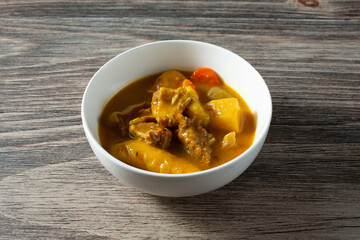 A view of a bowl of Jamaican style beef stew.