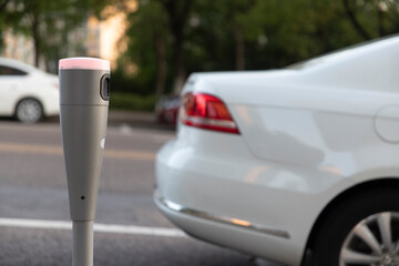 Modern intelligent parking timing and toll collection equipment, with cars parked on the roadside automatically sensing timing and toll collection