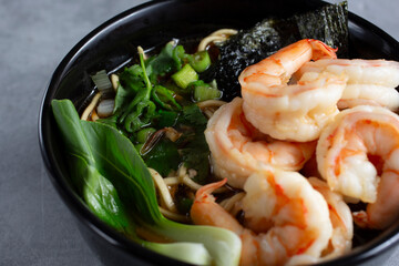 A closeup view of a bowl of shrimp noodle soup.