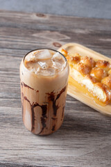 A view of an iced mocha beverage and a Yemeni beehive bread slice.