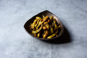 A view of a plate of spicy edamame.
