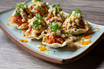 A view of a plate of ahi tuna on fried wontons.
