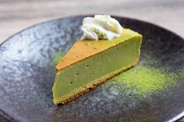 A view of a slice of matcha cheesecake.