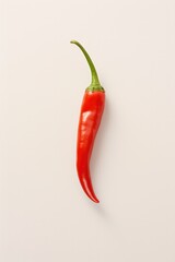 One red chili on white background.