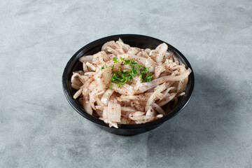 A view of a bowl of marinated sumac onions.