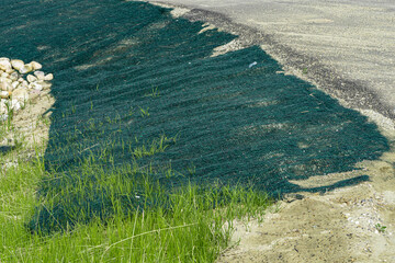 New road slope erosion stbilization protection with green net cover