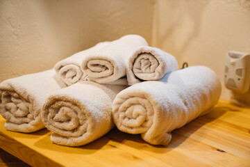 Hand and body towels rolled up by the washstand.