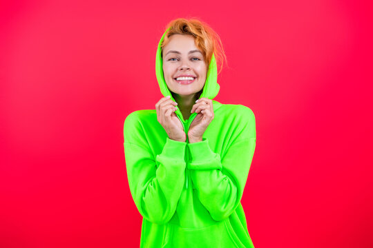 Stylish Caucasian woman in casual hoodie. Fashionista girl look trendy and bright. Woman with wearing hoodie isolated on pink. Fashion model. Redhead girl in stylish hoodie. Relaxed sophistication