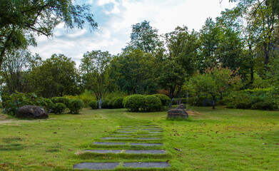 Under the clear sky, the parks in the city are lush with green grass and very quiet