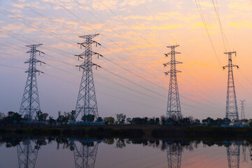 Fototapeta premium In the evening, the high-voltage power tower stands tall and spectacular in the park on the outskirts of the city