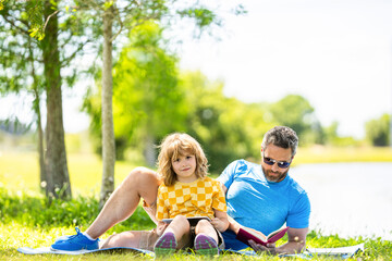 Fototapeta premium son with daddy bonding in summer. education of daddy and son child. daddy inspire educational journey of his son kid. daddy and son relax in park. childhood school education. nature and learning meet