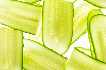 Beautiful fresh transparent cucumber slices on white background